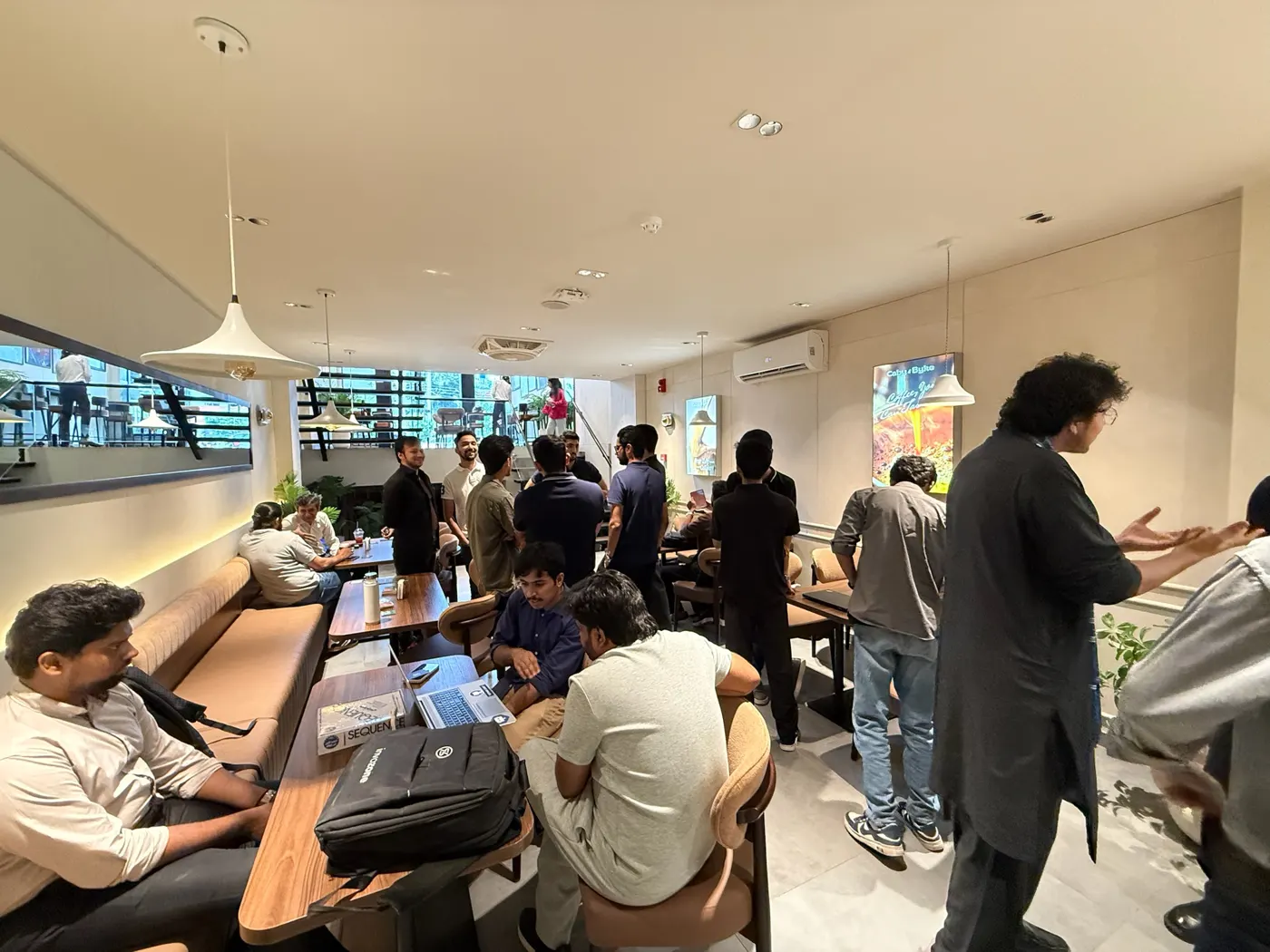 Guests standing and talking in groups at UnMixer