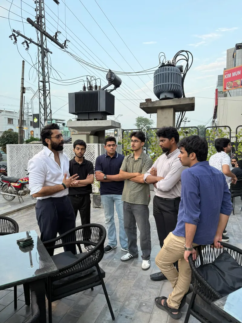 A circle of guests talking on the terrace outside